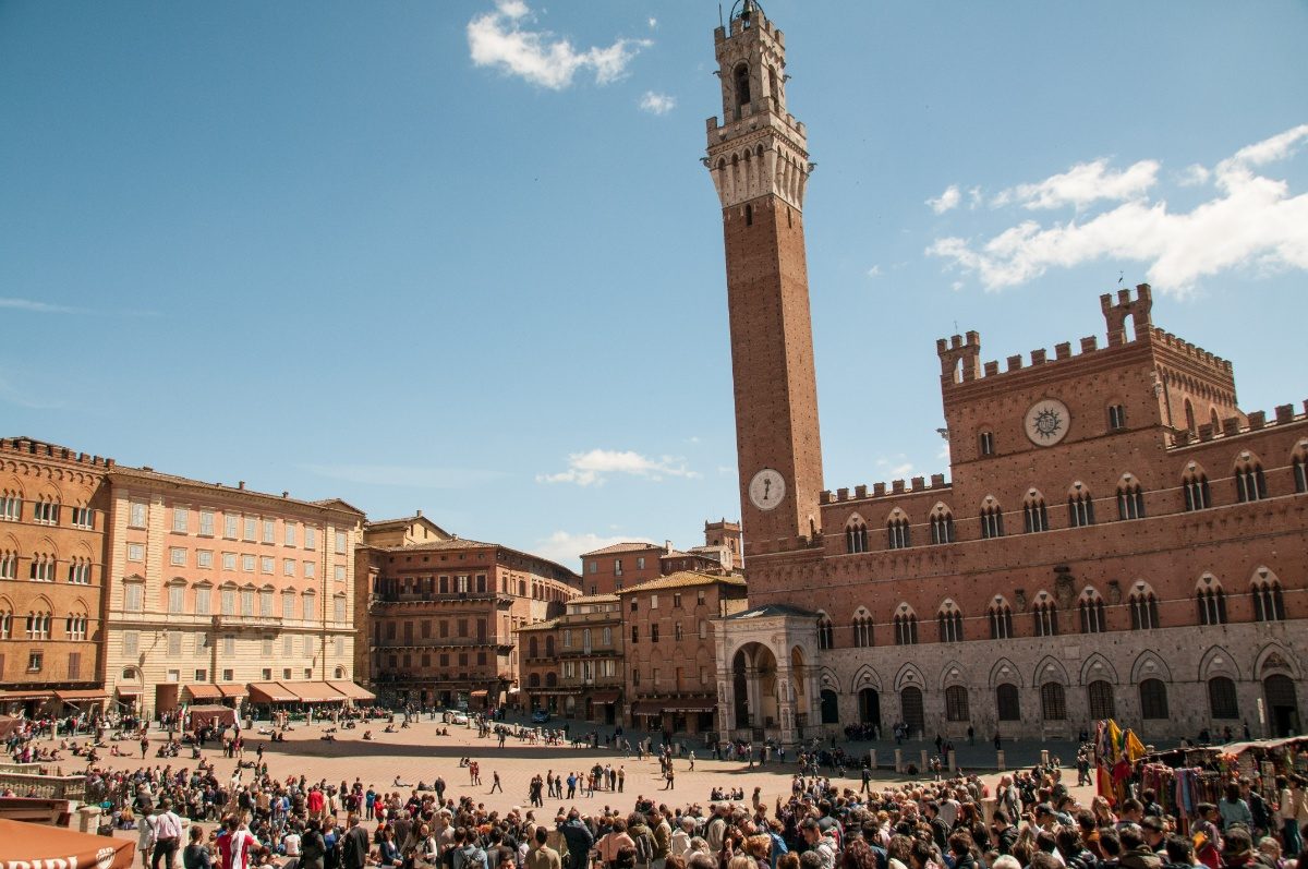 Tourist and locals exploring the Piazza del Campo in Siena, Italy