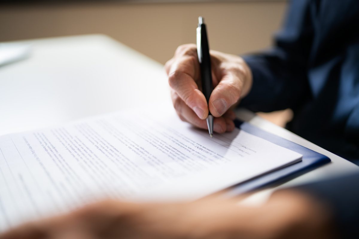 Man signing papers and documents 