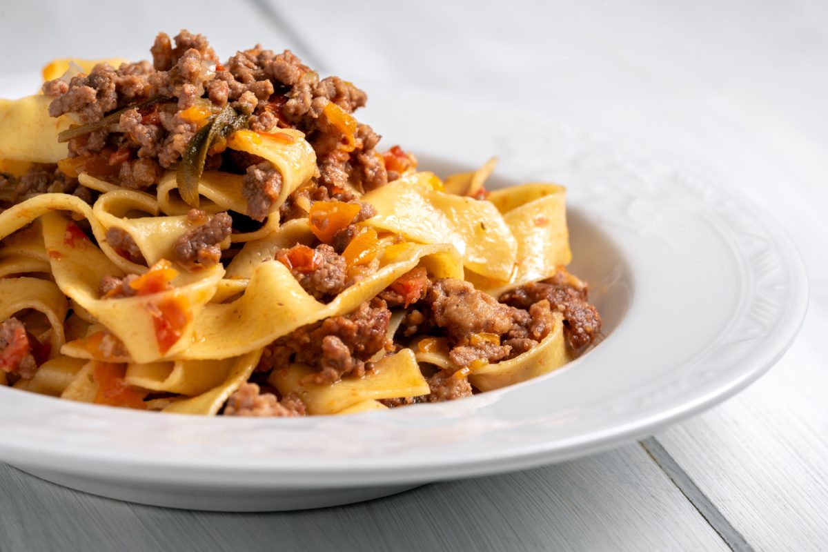 Close-up of Tagliatelle al Ragù pasta served on a white plate