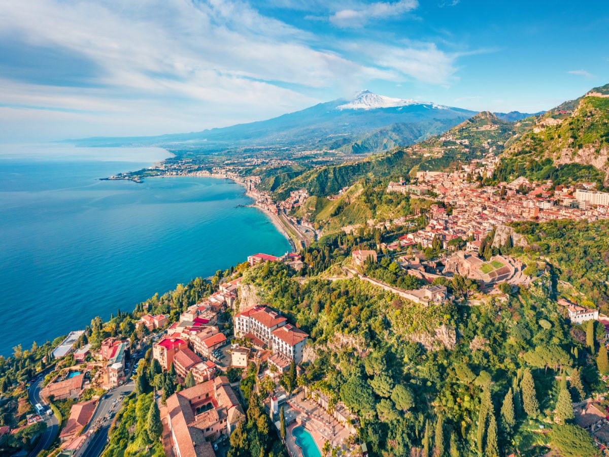 Aerial view of Taormina town and Etna volcano in Italy