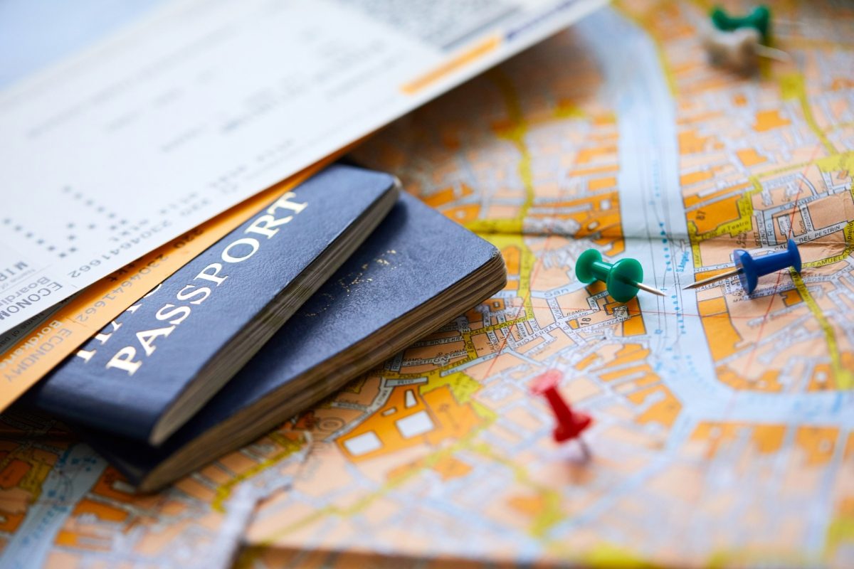 Travel documents and passports neatly placed on top of a map