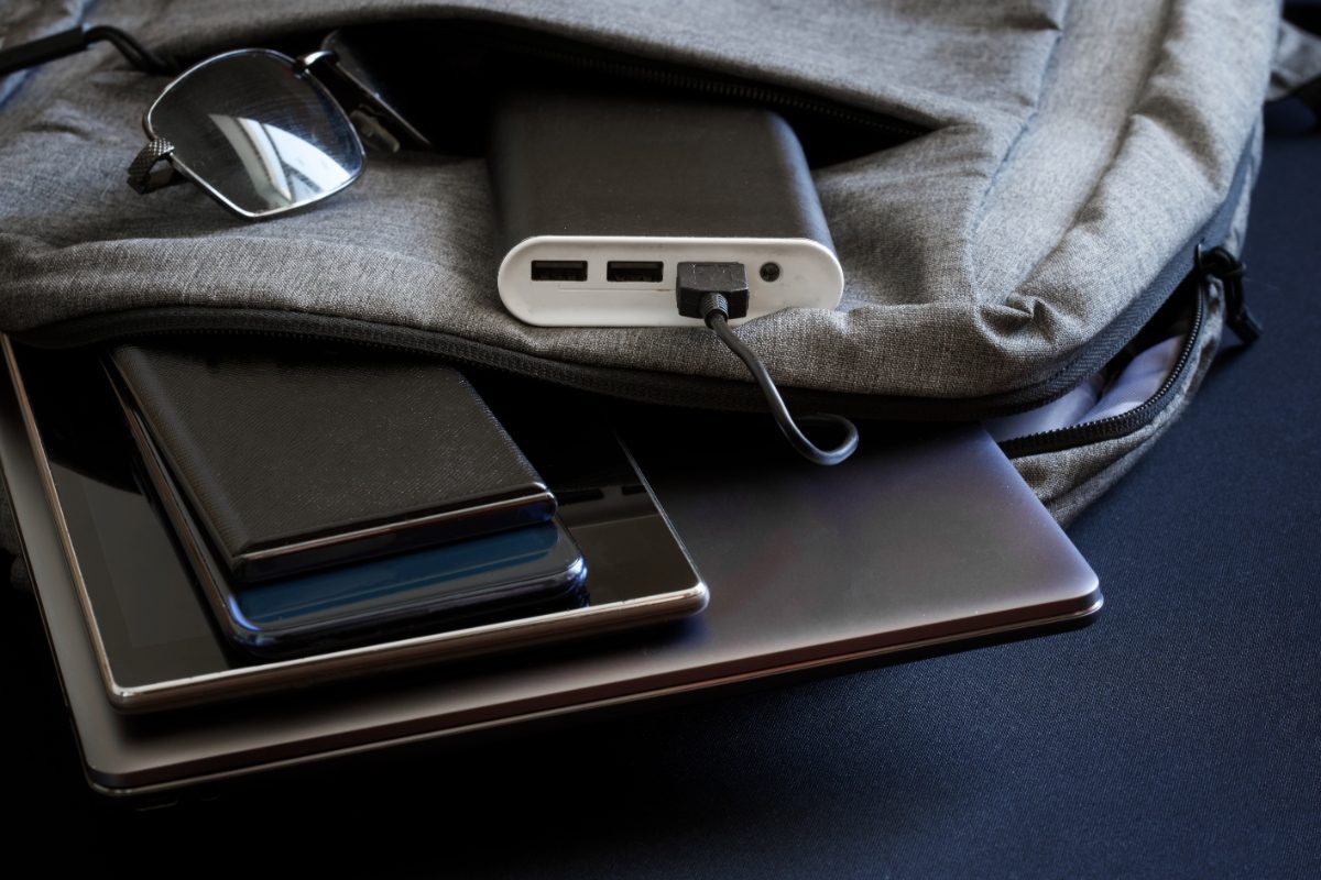 Close-up of different travel elecronics and a portable charger