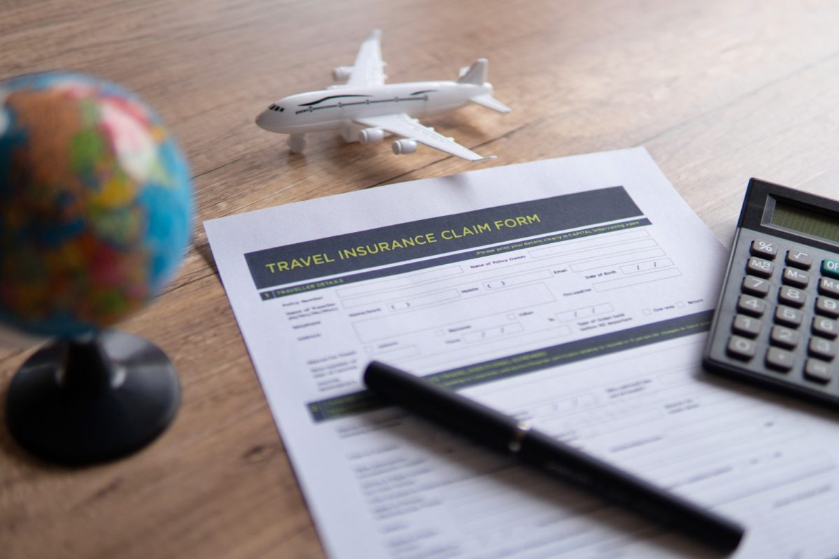 Close-up of a travel insurance claim form on a wooden table