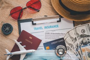 Close-up of travel insurance documents and travel essentials