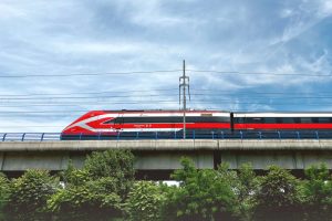 Trenitalia speed train passing on the bridge in Italy