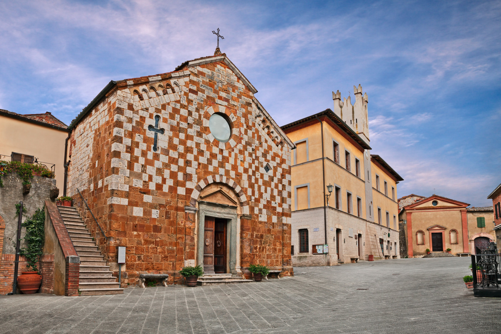 Medieval church and the view of the main square at Trequanda, Siena in Tuscany, Italy