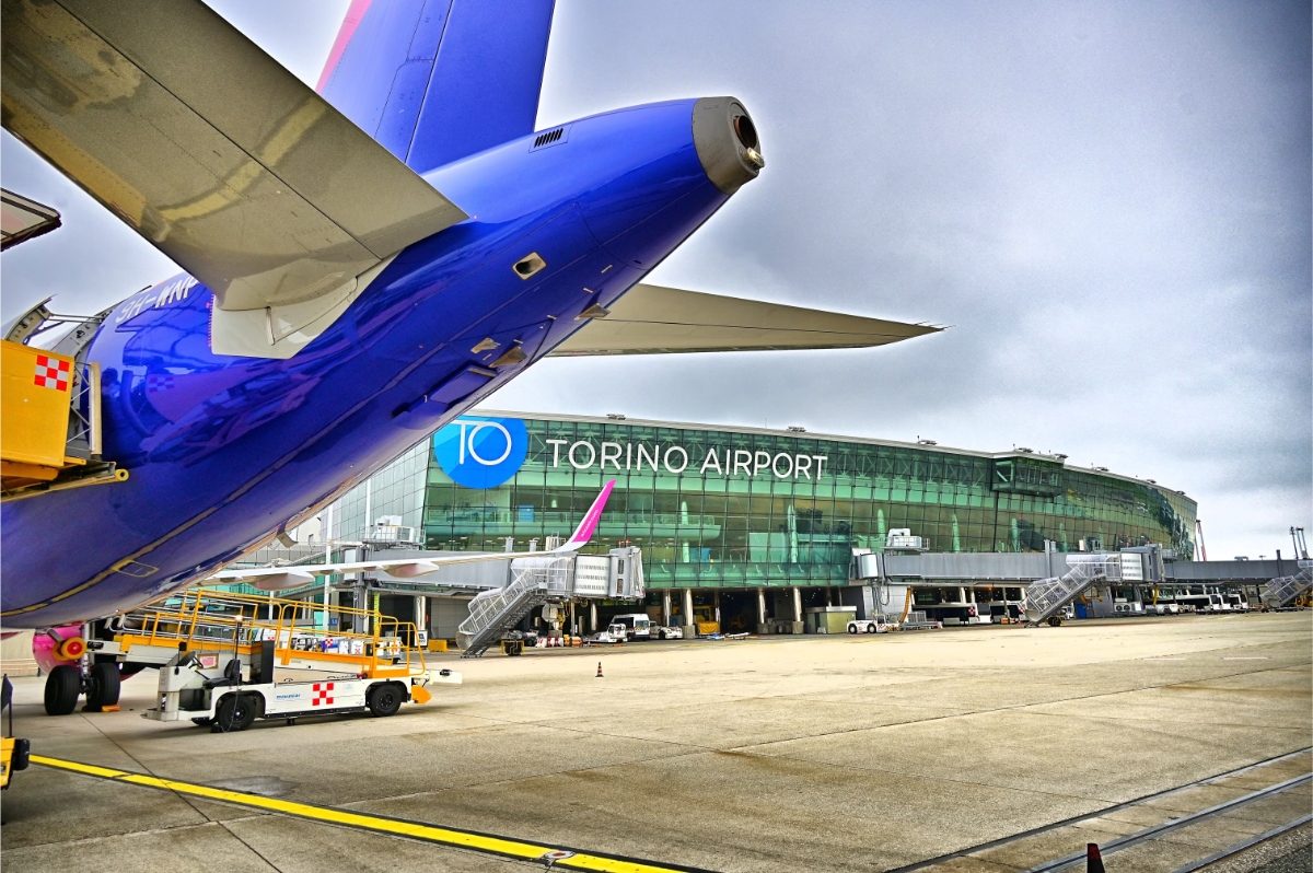 Exterior view of international airport terminal of Turin Airport and it's runway in Turin, Italy