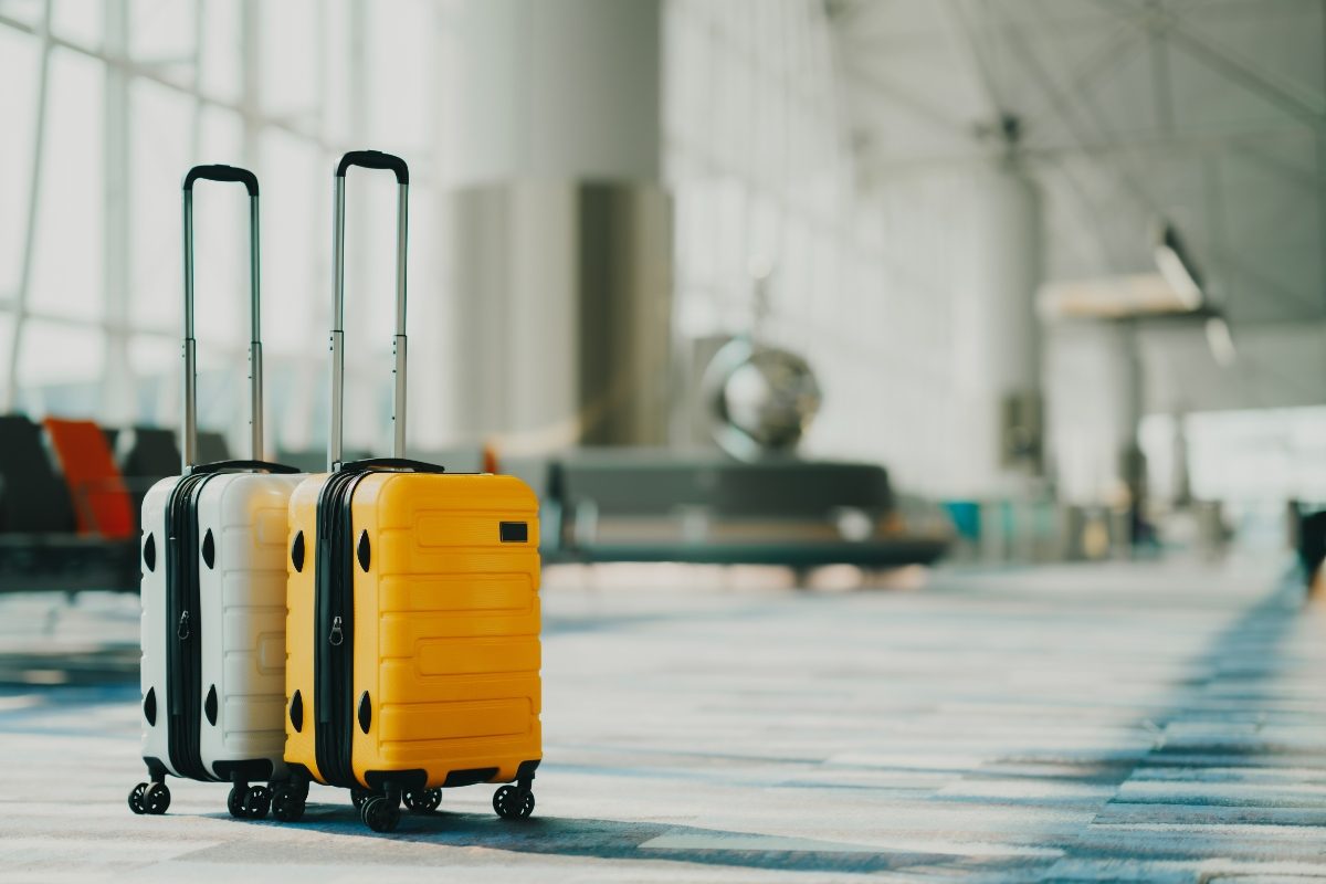 Close-up of two suitcases in an airport hall