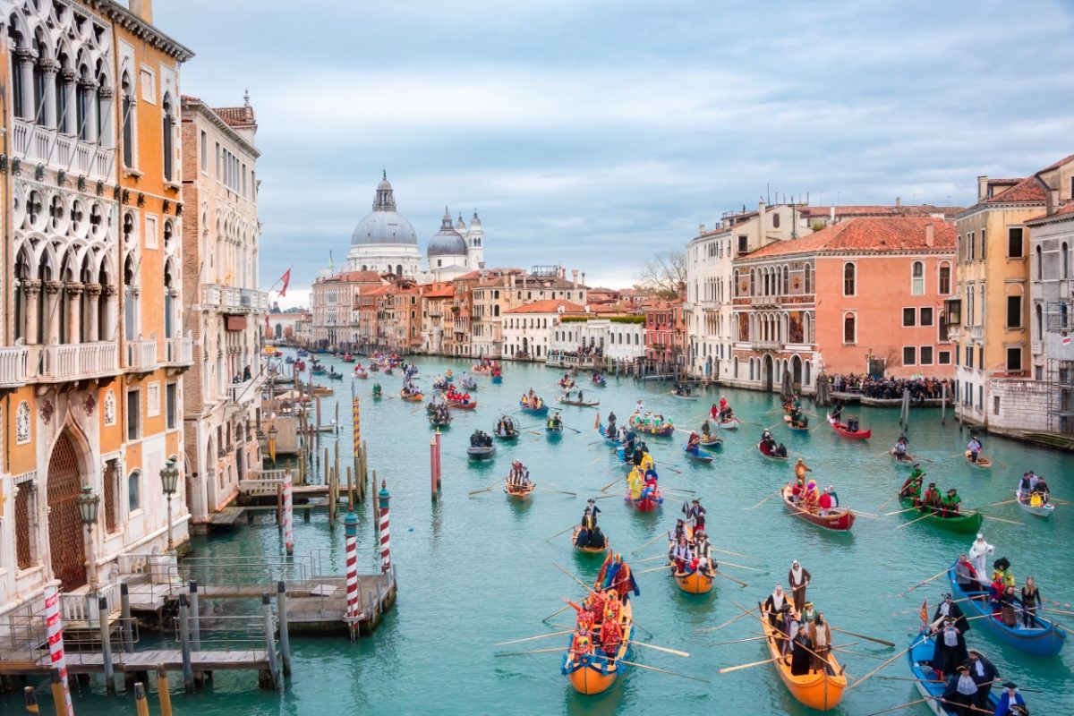 Panoramic view of Venice carnival opening with gondola boat water parade in Venice, Italy