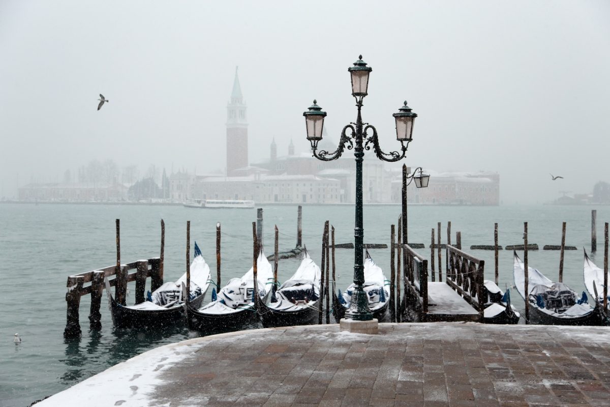 Gondolas at Venice, Italy covered in winter snow