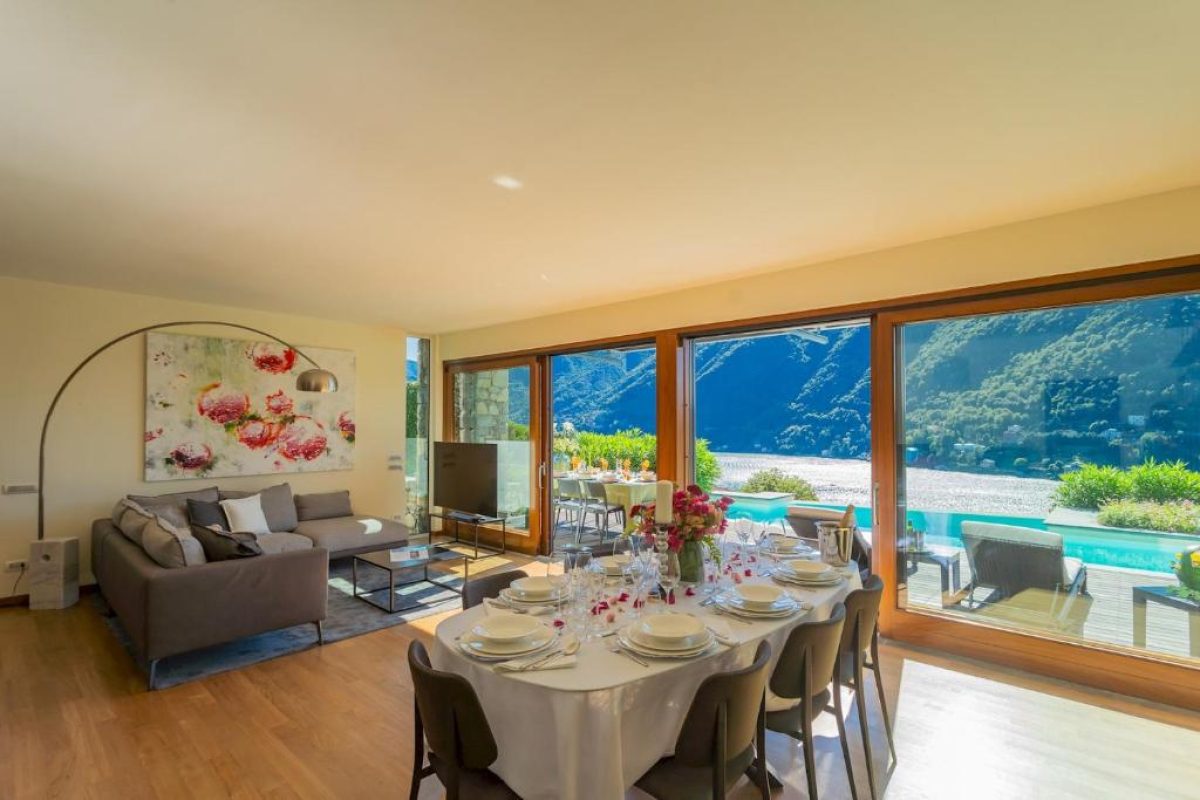 Dining table and living room of Villa Infinity Lake Como by Rent All Como