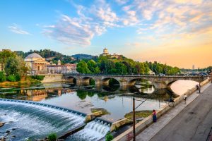 Panoramic sunset view of the Church of Monte dei Cappuccini and the Vittorio Emanuel I Bridge in Turin, Italy