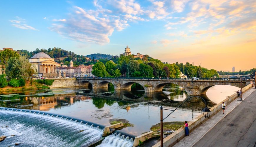 Panoramic sunset view of the Church of Monte dei Cappuccini and the Vittorio Emanuel I Bridge in Turin, Italy