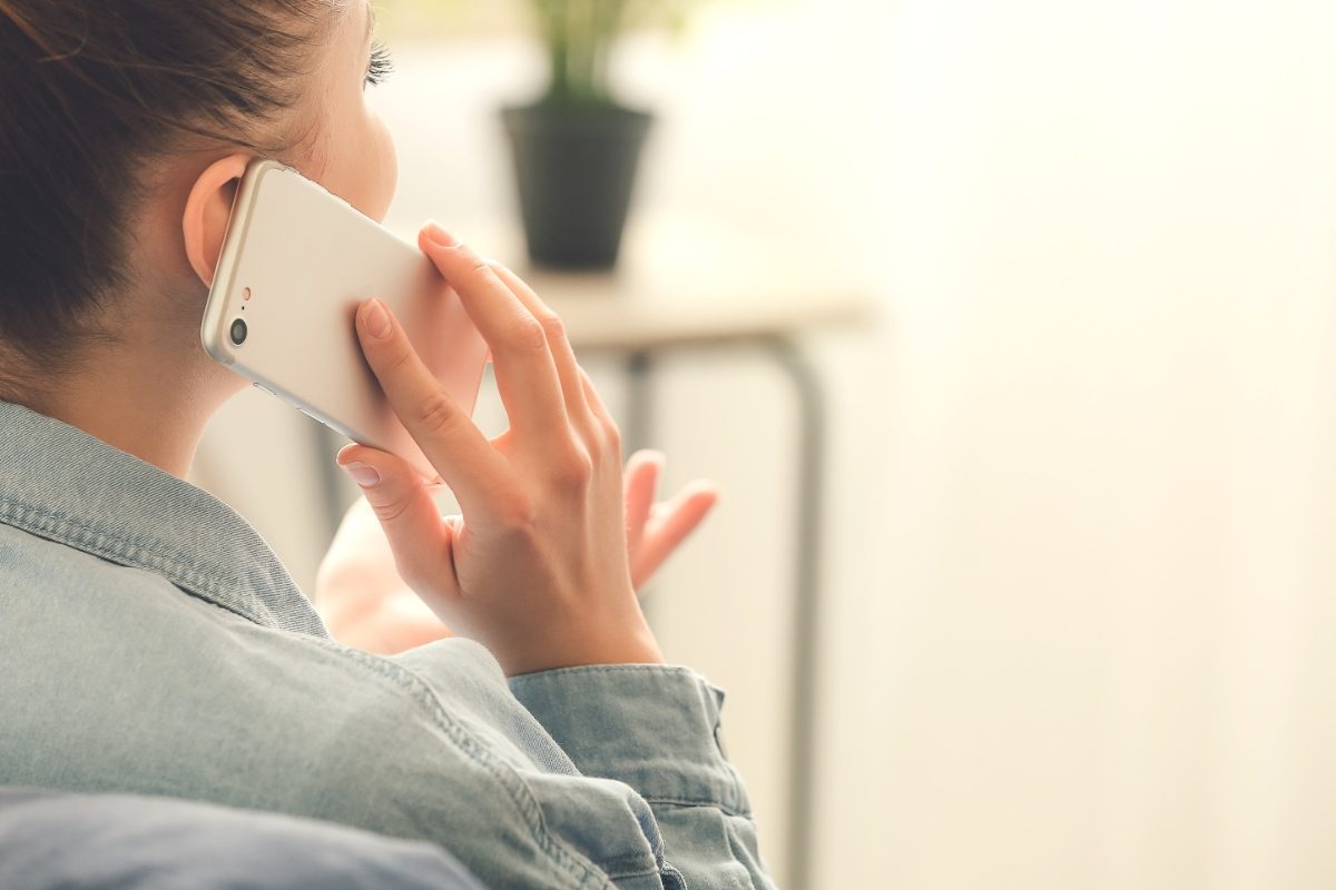 Woman holding phone while on a phone call